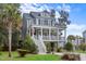 Two-story house with gray siding, white porch, and a landscaped lawn at 2166 Brown Pelican Ln, Charleston, SC 29412