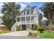 Two-story house with gray siding, white porch, and a landscaped lawn at 2166 Brown Pelican Ln, Charleston, SC 29412