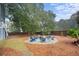 Relaxing fire pit surrounded by blue chairs in backyard at 2166 Brown Pelican Ln, Charleston, SC 29412