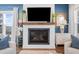 Modern fireplace with white shiplap surround and a dark mantel at 2166 Brown Pelican Ln, Charleston, SC 29412