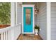 Bright teal front door with glass panel and welcome mat at 2166 Brown Pelican Ln, Charleston, SC 29412