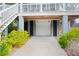 White double-car garage below elevated home at 2166 Brown Pelican Ln, Charleston, SC 29412