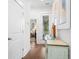 Light and airy hallway with hardwood floors and access to bedrooms and balcony at 2166 Brown Pelican Ln, Charleston, SC 29412