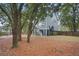 Gray house exterior with a large backyard and trees at 2166 Brown Pelican Ln, Charleston, SC 29412