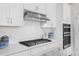 Modern kitchen features gas cooktop, white cabinets and subway tile backsplash at 2166 Brown Pelican Ln, Charleston, SC 29412