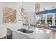 Kitchen island with sink, quartz countertops and a view into the dining area at 2166 Brown Pelican Ln, Charleston, SC 29412