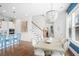 Open concept kitchen with white cabinets, island, and blue barstools at 2166 Brown Pelican Ln, Charleston, SC 29412
