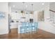 Modern kitchen with white cabinets, quartz countertops, and blue island seating at 2166 Brown Pelican Ln, Charleston, SC 29412