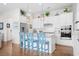 Bright kitchen with white cabinets, stainless steel appliances, and a breakfast bar at 2166 Brown Pelican Ln, Charleston, SC 29412