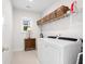 Bright laundry room with washer, dryer, and ample storage at 2166 Brown Pelican Ln, Charleston, SC 29412