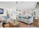 Open living room with hardwood floors, comfortable seating, and kitchen views at 2166 Brown Pelican Ln, Charleston, SC 29412