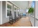 Relaxing front porch with rocking chairs and porch swing at 2166 Brown Pelican Ln, Charleston, SC 29412