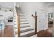 Elegant wooden staircase leading to the second floor at 2166 Brown Pelican Ln, Charleston, SC 29412