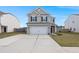 Two-story house with gray siding, white garage door, and a landscaped lawn at 230 Wathen Dr, Goose Creek, SC 29445