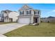 Two-story house with gray siding, white garage door, and a landscaped lawn at 230 Wathen Dr, Goose Creek, SC 29445