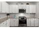 White shaker cabinets, granite countertops, and stainless steel appliances at 230 Wathen Dr, Goose Creek, SC 29445