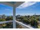 Ocean view from a balcony with white railing and tropical landscape at 305 Matilda St, Edisto Beach, SC 29438