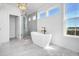 Luxurious bathroom with a freestanding tub, walk-in shower, and marble flooring at 305 Matilda St, Edisto Beach, SC 29438