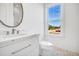 Stylish bathroom featuring a white vanity, marble countertop, and hexagon tile floor at 305 Matilda St, Edisto Beach, SC 29438