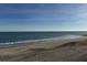 Sandy beach with ocean waves and clear sky at 305 Matilda St, Edisto Beach, SC 29438