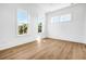 Bright bedroom with hardwood floors and large windows offering natural light at 305 Matilda St, Edisto Beach, SC 29438