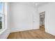 Well-lit bedroom with hardwood floors and laundry access at 305 Matilda St, Edisto Beach, SC 29438