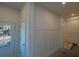 Bright entryway with white walls, wood stairs, and a door at 305 Matilda St, Edisto Beach, SC 29438