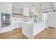 Modern kitchen with white cabinets, double ovens, and large island at 305 Matilda St, Edisto Beach, SC 29438