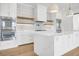 Modern kitchen with white cabinets, double ovens, and large island at 305 Matilda St, Edisto Beach, SC 29438