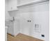 Well-appointed laundry room with white cabinets, countertop, and built-in shelving at 305 Matilda St, Edisto Beach, SC 29438
