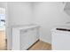 Functional laundry room with white cabinets and a built-in sink at 305 Matilda St, Edisto Beach, SC 29438