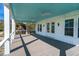 Spacious porch with light blue ceiling and ceiling fans at 305 Matilda St, Edisto Beach, SC 29438
