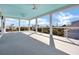Spacious porch with cable railing, light grey floor, and blue ceiling at 305 Matilda St, Edisto Beach, SC 29438