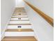 Modern staircase with wood treads and white risers, illuminated by recessed lighting at 305 Matilda St, Edisto Beach, SC 29438