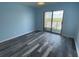 Spacious bedroom with hardwood floors and sliding glass door to balcony at 3701 Docksite Rd # 320, Edisto Beach, SC 29438