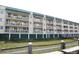 Multi-story building with balconies and green accents at 3701 Docksite Rd # 320, Edisto Beach, SC 29438