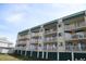 Multi-story building with balconies and green accents at 3701 Docksite Rd # 320, Edisto Beach, SC 29438