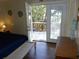 Bedroom with deck access and coastal-themed decor at 506 Jungle Rd, Edisto Island, SC 29438
