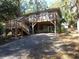 Elevated cottage with wrap-around deck and spacious backyard at 506 Jungle Rd, Edisto Island, SC 29438