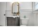 Charming bathroom with gray vanity, white toilet, and gold accents at 5259 Hartford Cir, North Charleston, SC 29405