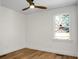 Spacious bedroom featuring hardwood floors, large window, and ceiling fan at 5259 Hartford Cir, North Charleston, SC 29405
