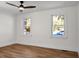 Well-lit bedroom with hardwood floors and two large windows at 5259 Hartford Cir, North Charleston, SC 29405