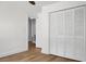 Bedroom with hardwood floors, white closet doors, and access to another room at 5259 Hartford Cir, North Charleston, SC 29405