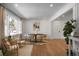 Modern dining room with a round table, six chairs, and large windows offering natural light at 5259 Hartford Cir, North Charleston, SC 29405