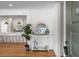 Bright and airy entryway with white wainscoting, a large mirror, and a view into the kitchen at 5259 Hartford Cir, North Charleston, SC 29405