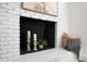 White brick fireplace with candles and decor at 5259 Hartford Cir, North Charleston, SC 29405