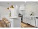 Stylish kitchen boasts white cabinets, a farmhouse sink, and marble backsplash at 5259 Hartford Cir, North Charleston, SC 29405