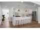 Updated kitchen with white cabinets, marble backsplash, and an island with seating at 5259 Hartford Cir, North Charleston, SC 29405