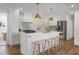 Bright white kitchen features a large island and stainless steel appliances at 5259 Hartford Cir, North Charleston, SC 29405