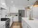 Modern kitchen with white cabinets, stainless steel appliances, and marble countertops at 5259 Hartford Cir, North Charleston, SC 29405